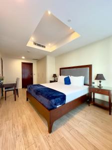 a bedroom with a large bed and a desk at One Bedroom apartment Centaurus Islamabad in Islamabad +23 photos