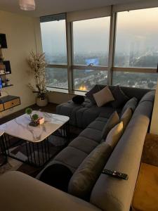 a living room with a couch and a table at One Bedroom apartment Centaurus Islamabad in Islamabad