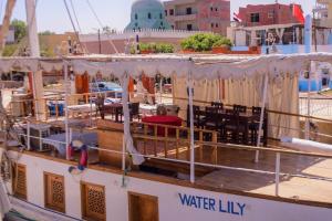a boat with tables and chairs on the deck at 1Water Lily in Luxor