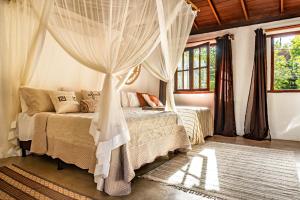 a bedroom with a bed with a canopy at La hospedaria in Trancoso +50 photos
