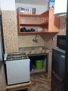 a kitchen with a sink and a stove in a kitchen at Mandeko in Abidjan