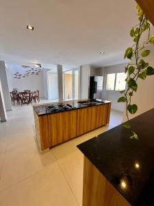 a large kitchen with a counter top in a room at Pipa Sunset Mansion in Pipa