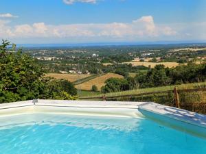 a swimming pool with a view of the countryside at La Montagne in Tournus