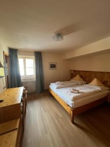 a large bedroom with two beds and a window at LAKE & RIVER Hotel in Carezza al Lago