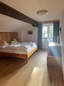 a bedroom with a large bed and a window at LAKE & RIVER Hotel in Carezza al Lago