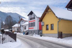 a street in a town with snow on the ground at Apartment Jursport in Závažná Poruba