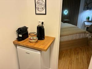 a small table with a coffee maker on top of a room at Studio number 3 in Pantin