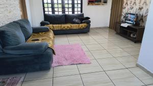 a living room with two couches and a pink rug at Pousada RC Q2 in Várzea Grande