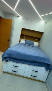a bedroom with a bed and a white cabinet at D Gomez House in Santiago de los Caballeros