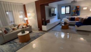 a large living room with couches and a tv at D Gomez House in Santiago de los Caballeros
