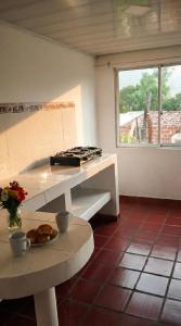 a kitchen with a stove and a table with a plate of food at Casa sendai2 in Buesaco