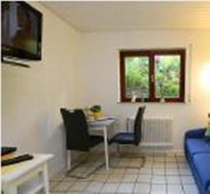 a living room with a table and chairs and a couch at wohnung-nr-2 in Kirchzarten