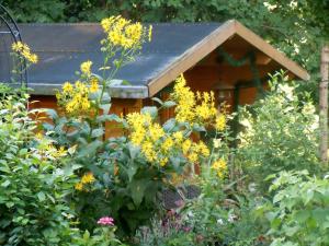 a bird house in a garden with flowers at wohnung-nr-2 in Kirchzarten