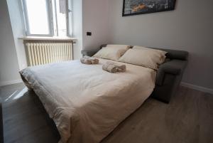 a bed with two stuffed animals on top of it at Centro-Appartamento SanMartino in Varese