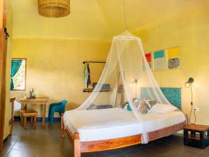 a bedroom with a bed with a mosquito net at Finca Aisa -Boutique bungalows in Ometepe island in Santa Cruz