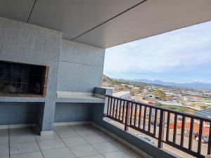a balcony with a view of a city at Vene's Place in Mossel Bay +1 photo
