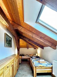 a bedroom with a bed and a window at Apartmán Jizerské údolí in Kořenov