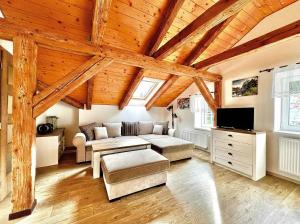 a living room with a couch and a table at Apartmán Jizerské údolí in Kořenov