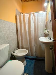 a bathroom with a toilet and a sink at Casa Mamani in Tilcara