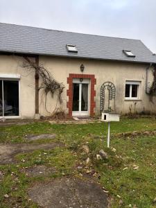 a house with a bird feeder in front of it at Jardin des prés in Le Thil-en-Vexin