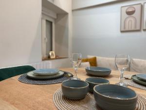 a table with plates and wine glasses on it at COCON Mayennais - Loft Balnéo Laval in Laval