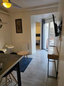 a living room with a table and a dining room at Kimme blue - terrasse exceptionnelle plein centre in Orléans