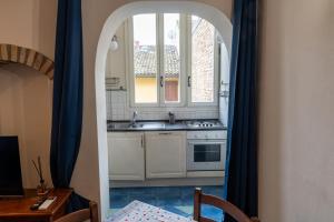 a kitchen with a sink and a window at Suite Cerchio 2 - City Center in Ravenna