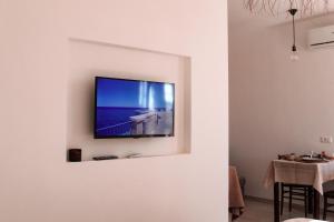 a television hanging on a wall in a living room at Dimora Caggione in Polignano a Mare +60 photos