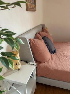 a couch with two pillows on it next to a table at Servus Chiemgau - Große Wohnung mit Bergblick in Frasdorf +15 photos