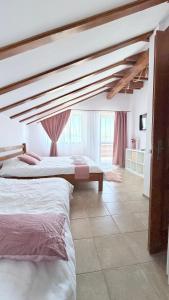 a bedroom with two beds and a large window at Ammon Mountain Villas in Bran +70 photos
