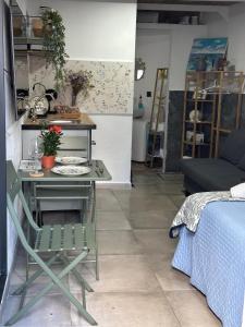 a room with a table and a chair and a bed at Buganvilla in Tarifa +14 photos