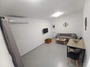 a living room with a couch and a table at Velania House 1 in Filótion