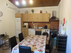 a kitchen with a table and a table and a kitchen with a table at MONTE DO SALTO DA RAPOSA in Figueira e Barros