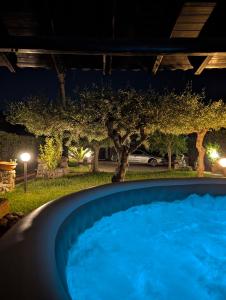 a swimming pool in a yard at night at Azure Bay Chic Villa in Fontane Bianche
