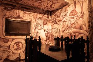 a room with a wall with a painting on it at Casa Orígenes Hotel Boutique in Pamplona