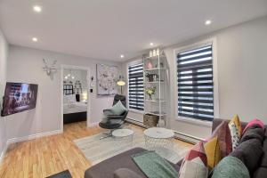 a living room with a couch and a chair at Bluenose in Quebec City