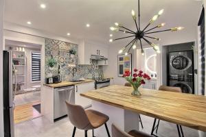 a kitchen with a wooden table and a dining room at Bluenose in Quebec City