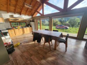 a dining room with a table and chairs in a kitchen at Cabaña Cholito in Lago Puelo