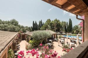 an exterior view of a resort with flowers and a swimming pool at Finca Es Torrent in Campos +9 photos