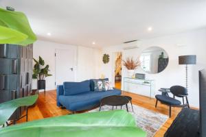 a living room with a blue couch and a table at Boutique duplex in Chiado with epic Rossio view in Lisbon +15 photos