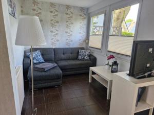 a living room with a couch and a table at Ferienhaus Marc in Göhren-Lebbin