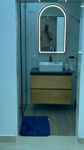 a man taking a picture of a bathroom with a mirror at Dgomez House in Santiago de los Caballeros +9 photos