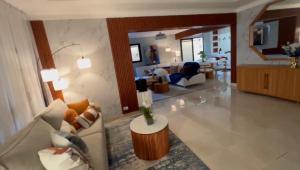 a living room with a couch and a table at Dgomez House in Santiago de los Caballeros