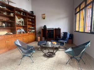 a living room with two chairs and a table at Casa Tierra Libre in Cali