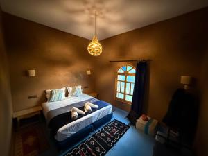 a bedroom with a bed with shoes on it at Dar Talhaya in Oulad Driss