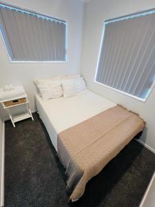 a small bedroom with a bed and a window at Unique homestay in Auckland