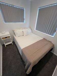 a small bedroom with a bed and a window at Unique homestay in Auckland