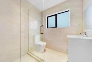 a bathroom with a shower and a toilet and a sink at Unique homestay in Auckland