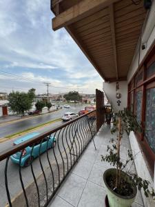 a balcony with a view of a street and cars at Hostal Asuncion in Arica