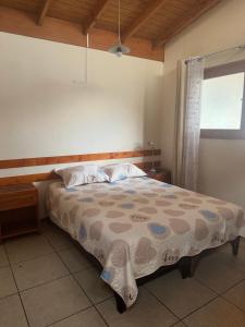 a bedroom with a bed and a window at Hostal Asuncion in Arica +4 photos